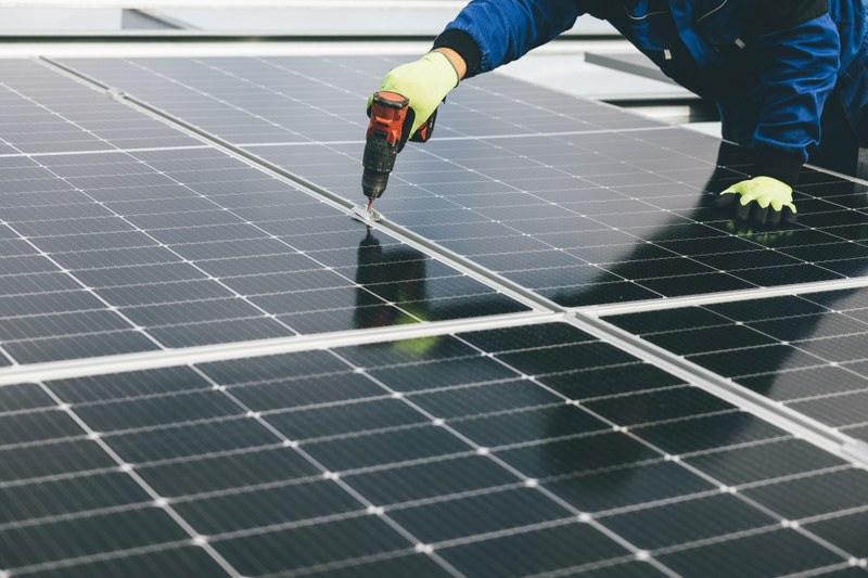 A person working on a solar panel
